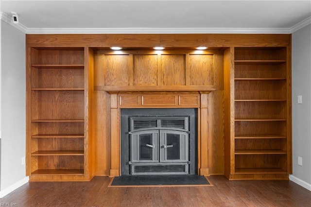 room details featuring crown molding, built in features, wood finished floors, and baseboards