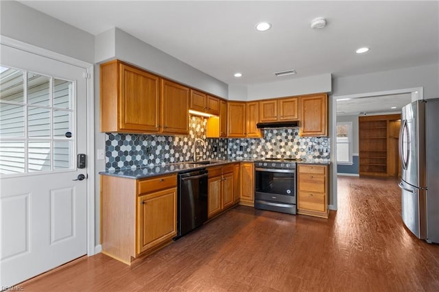 kitchen featuring dark wood-style flooring, visible vents, appliances with stainless steel finishes, and a sink