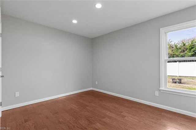 unfurnished room featuring recessed lighting, baseboards, and wood finished floors