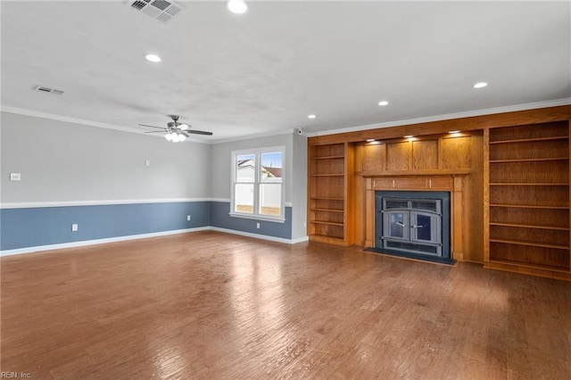 unfurnished living room featuring visible vents, ornamental molding, wood finished floors, recessed lighting, and baseboards