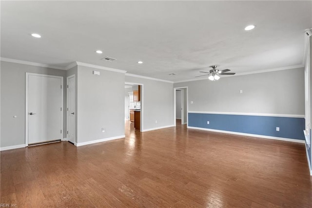 unfurnished room with crown molding, wood finished floors, and ceiling fan