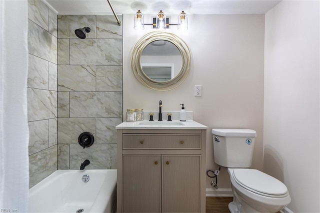 full bathroom featuring baseboards, toilet, shower / bath combo, and vanity