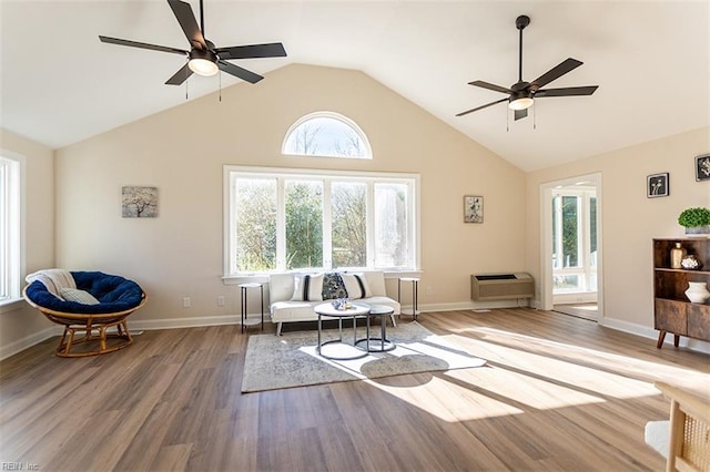 living area with high vaulted ceiling, a ceiling fan, baseboards, and wood finished floors