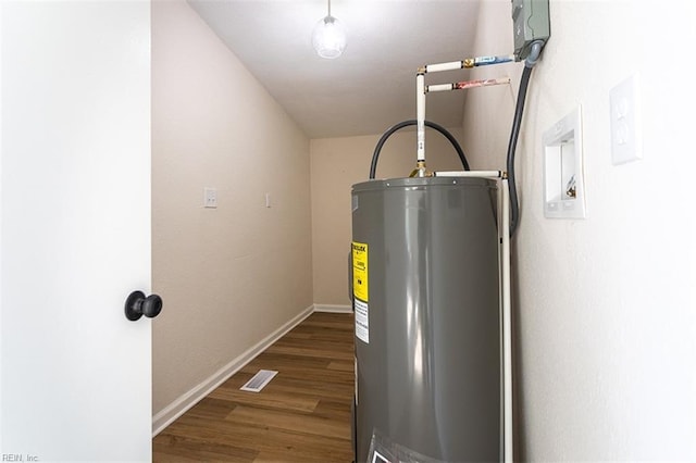 utility room featuring visible vents and electric water heater