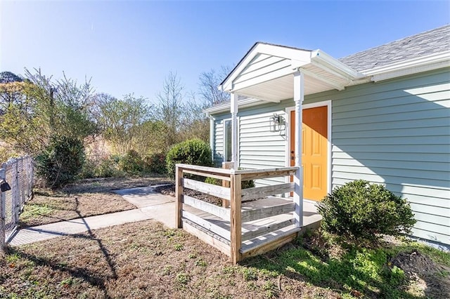 doorway to property with fence