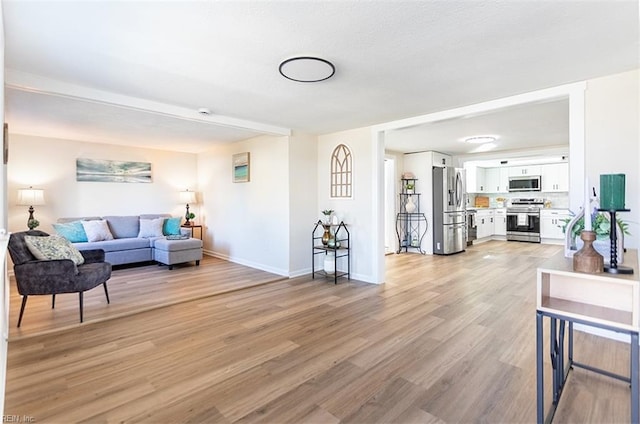 living area with baseboards and light wood-style floors