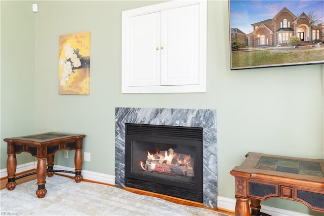 interior space with baseboards and a high end fireplace