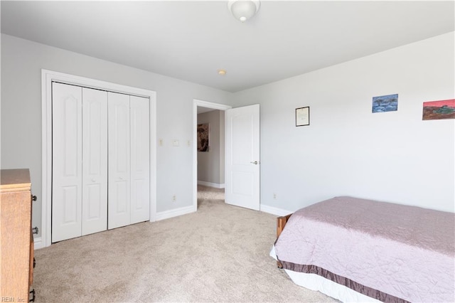 bedroom featuring a closet, baseboards, and carpet