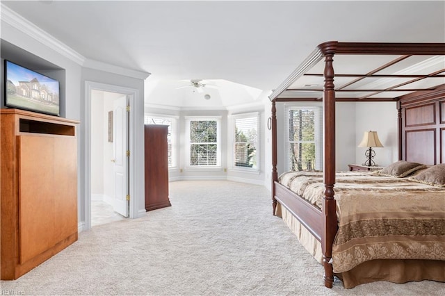 carpeted bedroom featuring ceiling fan, baseboards, ensuite bath, and ornamental molding