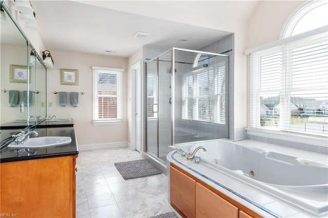 bathroom featuring a sink, a healthy amount of sunlight, and a shower stall