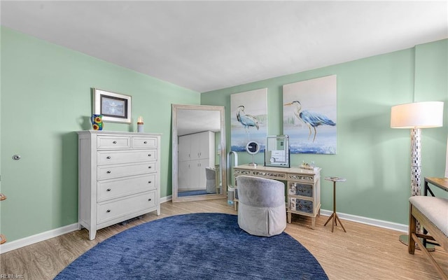 interior space with baseboards and light wood finished floors