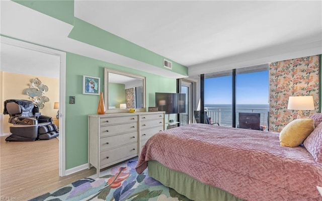 bedroom featuring visible vents, wood finished floors, and baseboards