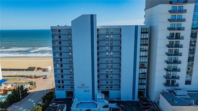 view of property with a view of the beach and a water view