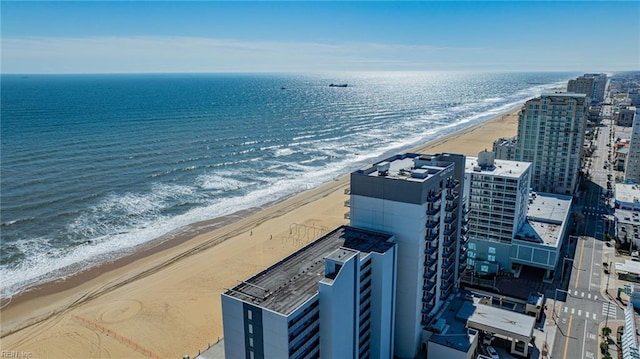 bird's eye view with a water view, a view of city, and a view of the beach