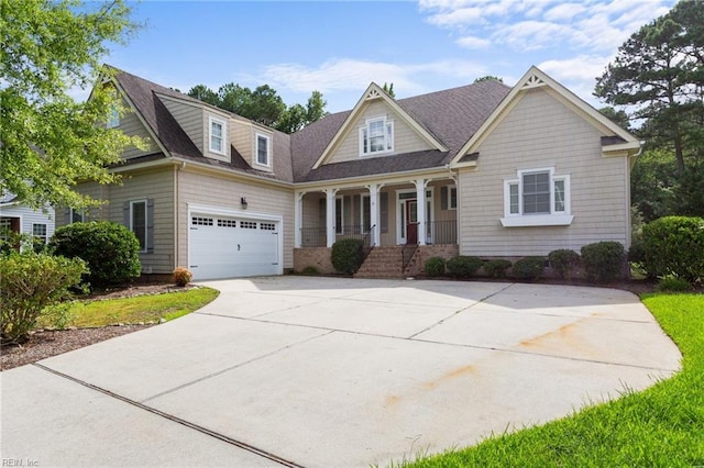 craftsman-style house featuring roof with shingles, covered porch, concrete driveway, and an attached garage