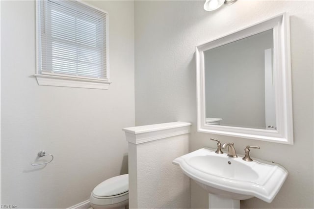 bathroom featuring toilet and a sink