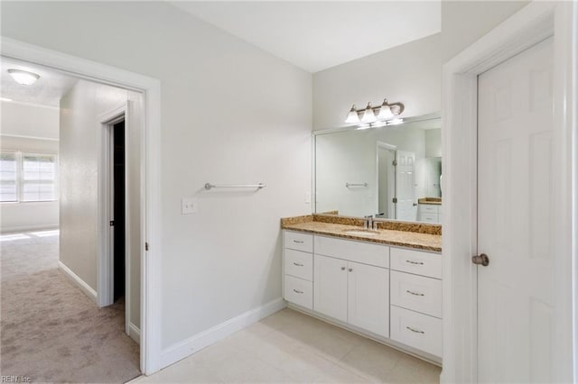 bathroom with vanity and baseboards