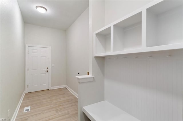 mudroom with visible vents, light wood-type flooring, and baseboards