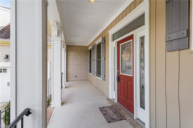 entrance to property with a porch and board and batten siding