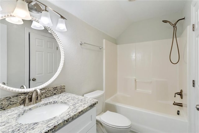 full bath with vanity, lofted ceiling, toilet, and shower / washtub combination