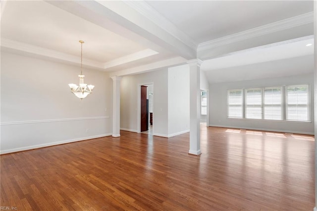 unfurnished room with baseboards, ornamental molding, an inviting chandelier, wood finished floors, and ornate columns