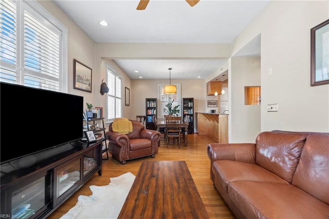 living room with recessed lighting, light wood-style floors, and ceiling fan