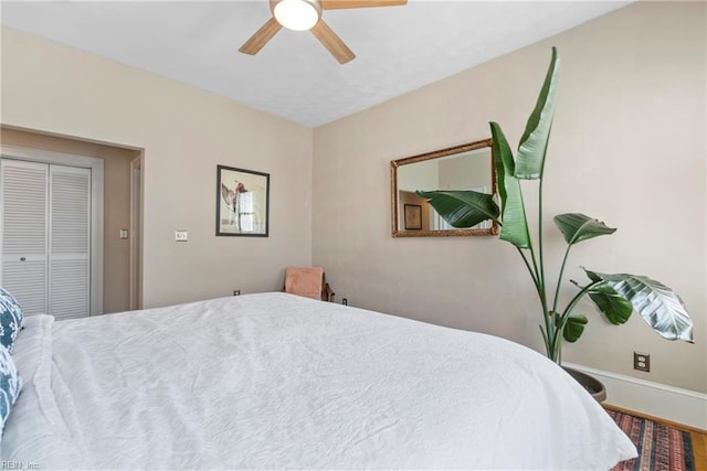 bedroom featuring baseboards, a closet, and ceiling fan