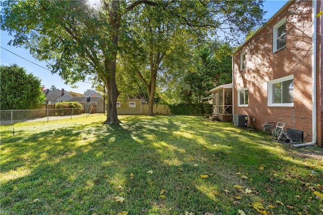 view of yard with an outbuilding, cooling unit, and a fenced backyard