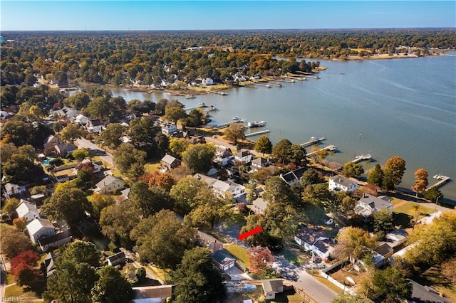 birds eye view of property with a residential view, a wooded view, and a water view