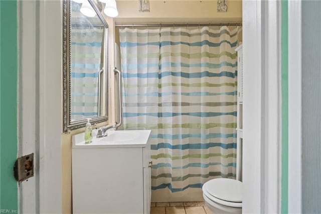 bathroom featuring tile patterned flooring, toilet, vanity, and a shower with curtain