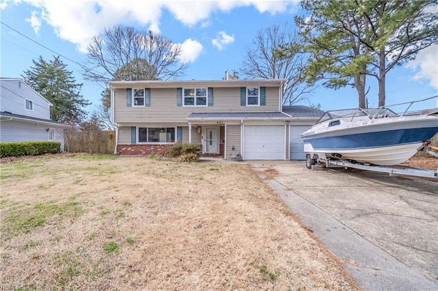 traditional home with brick siding, driveway, an attached garage, and a front yard