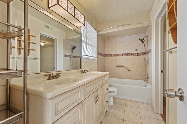 full bathroom with a sink, toilet, double vanity, and tile patterned flooring