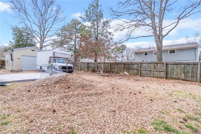 view of yard featuring an outbuilding and fence