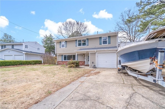 view of front of property with a garage, a front yard, concrete driveway, and brick siding