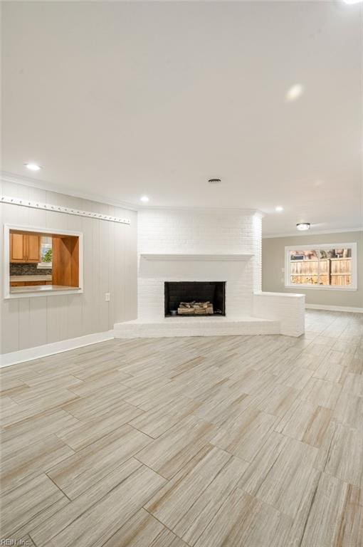 unfurnished living room featuring recessed lighting, baseboards, and a fireplace