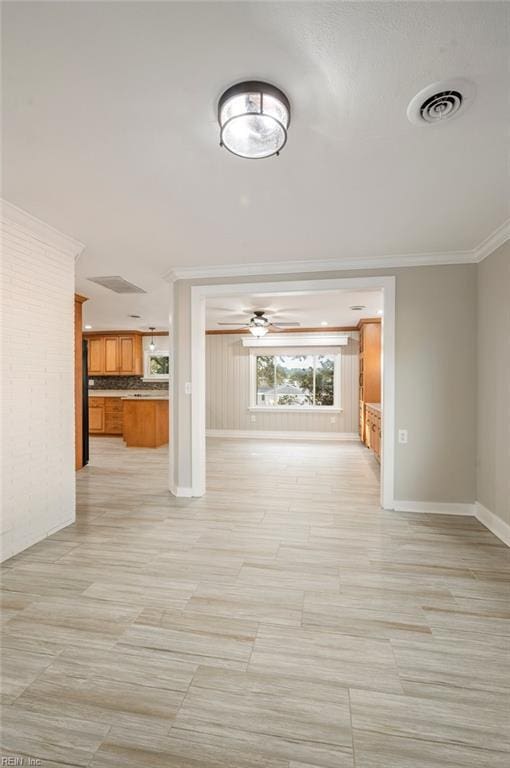 hallway with visible vents, crown molding, and baseboards