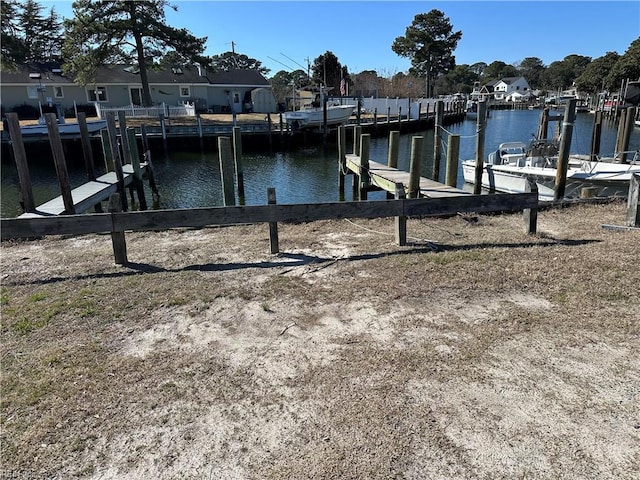 dock area featuring a residential view and a water view