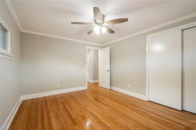 unfurnished bedroom with baseboards, light wood-type flooring, and ornamental molding