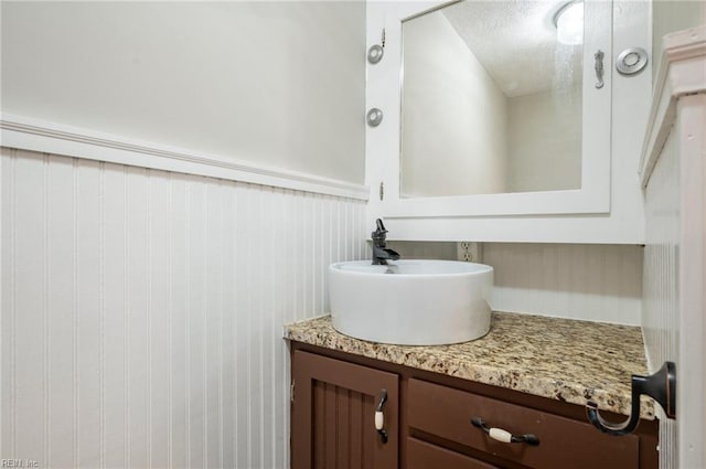 bathroom with vanity and wainscoting