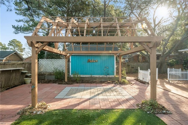 view of patio featuring a pergola and fence