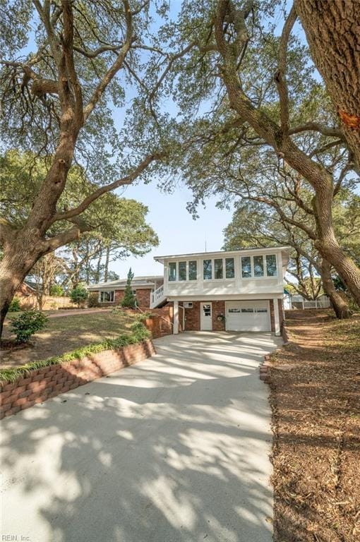 view of front of property with brick siding, driveway, and an attached garage