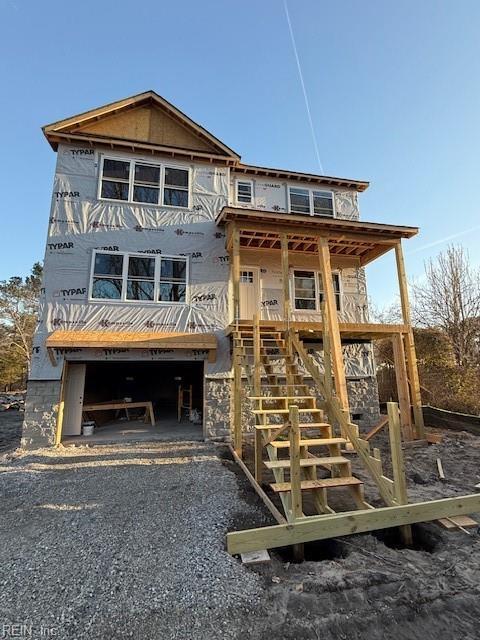 exterior space featuring stairway, an attached garage, and driveway