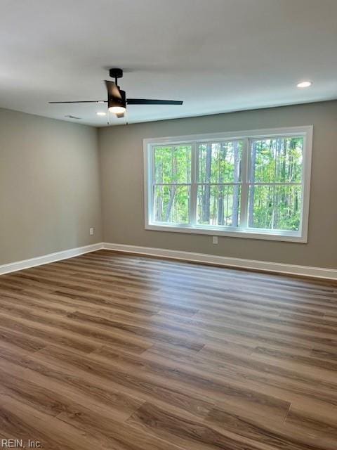 spare room featuring recessed lighting, baseboards, wood finished floors, and a ceiling fan