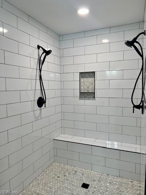 bathroom with a tile shower