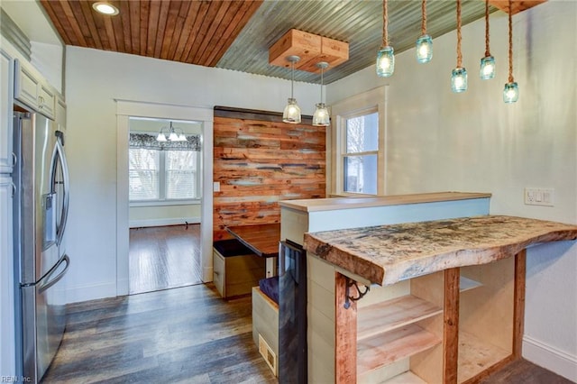 kitchen featuring plenty of natural light, wood ceiling, dark wood finished floors, and stainless steel refrigerator with ice dispenser