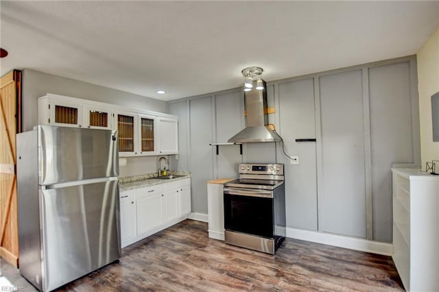 kitchen featuring dark wood-style floors, appliances with stainless steel finishes, ventilation hood, and a sink