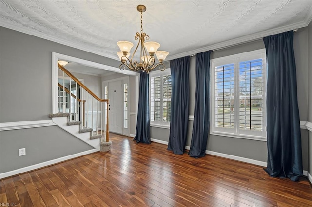 interior space with baseboards, hardwood / wood-style floors, and crown molding