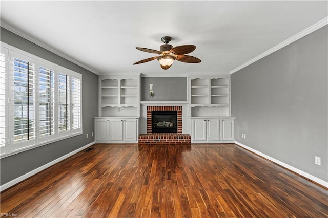 unfurnished living room with dark wood finished floors, a brick fireplace, baseboards, and ornamental molding