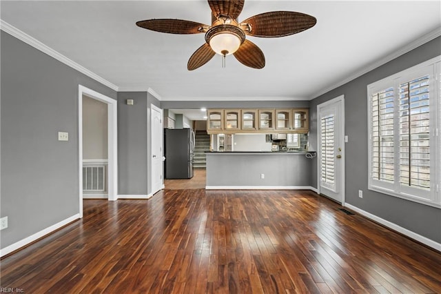 unfurnished living room with dark wood-type flooring, visible vents, baseboards, and ornamental molding