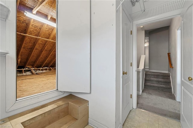 interior space featuring light colored carpet and stairs